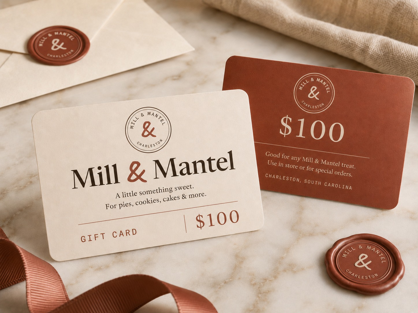 A Mill & Mantel gift card in cream and jam, with ribbon and a wax seal
